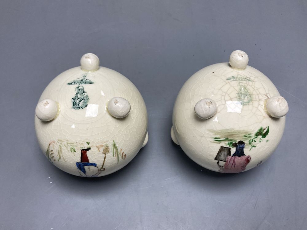 A pair of globular earthenware posy vases, height 10cm